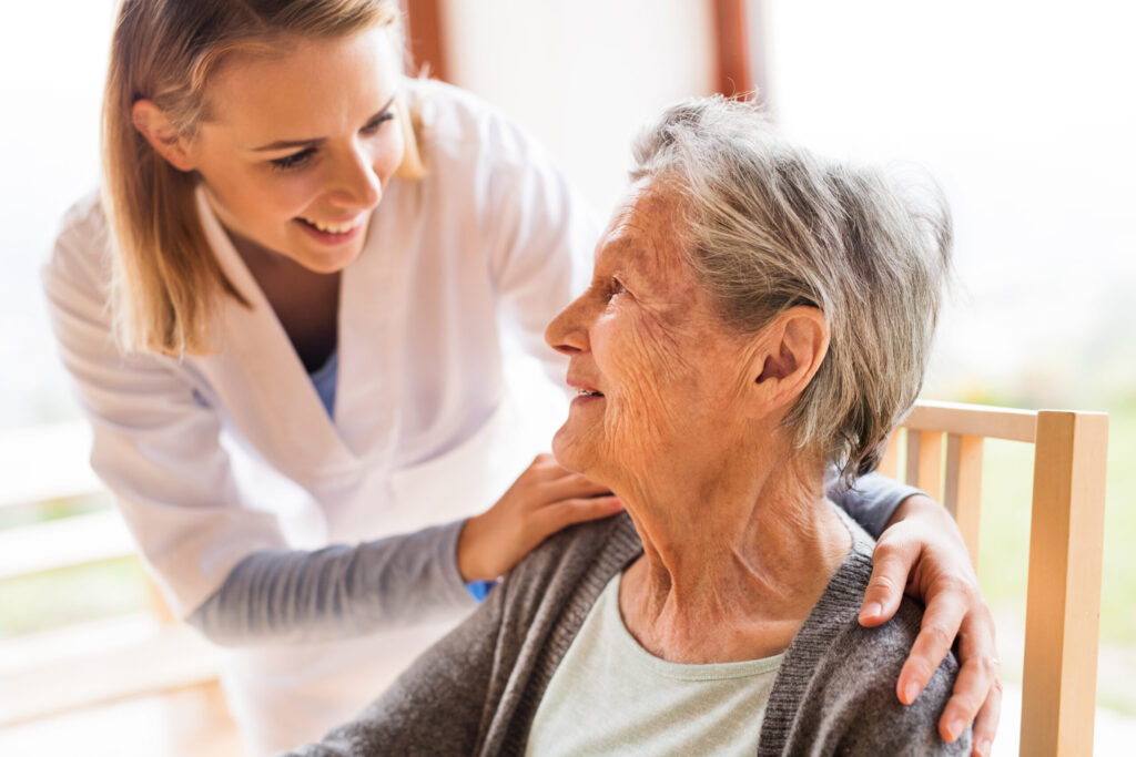 health visitor and a senior woman during home visit.